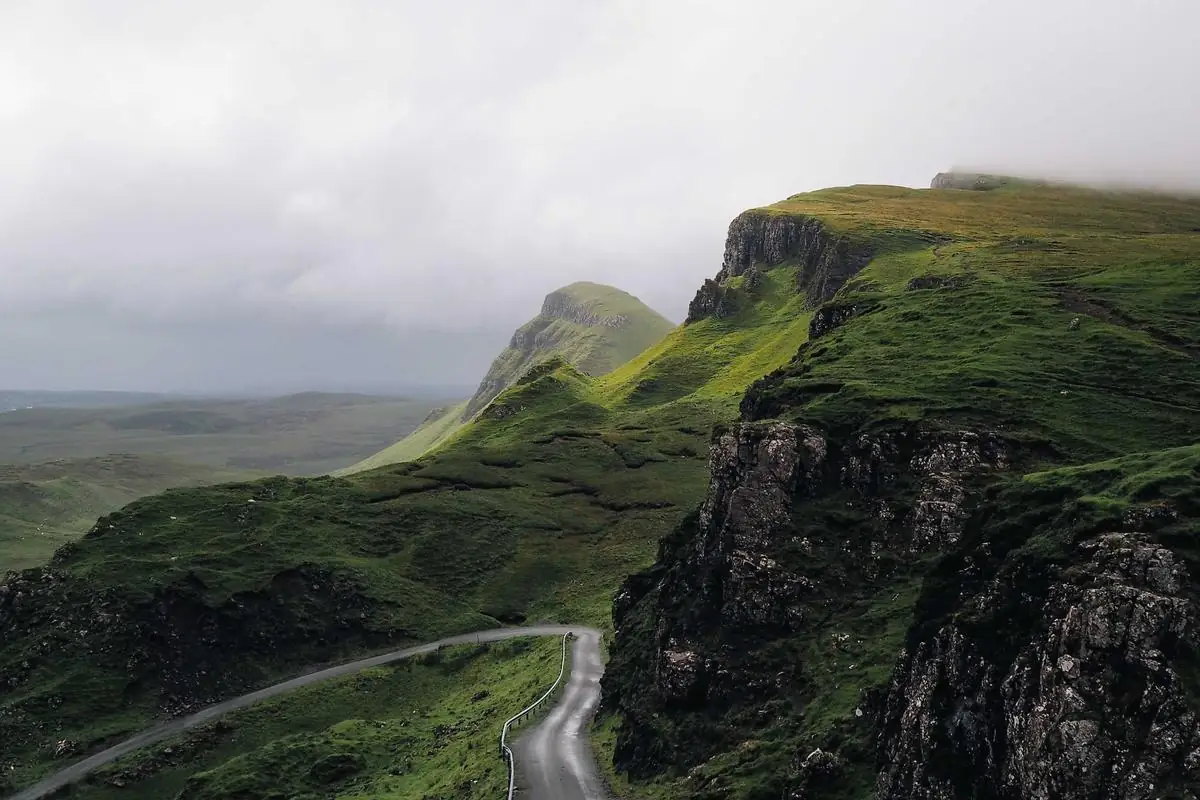 Green hills rolling under an overcast sky
